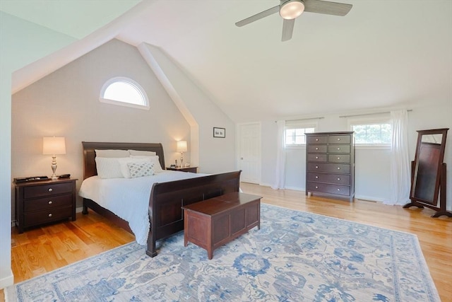 bedroom with vaulted ceiling, wood finished floors, and ceiling fan