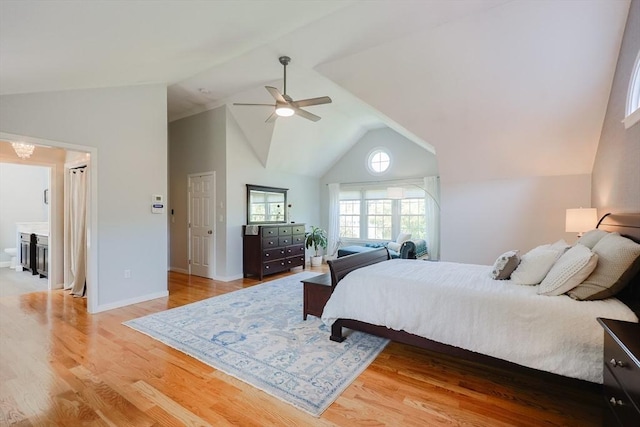 bedroom featuring light wood-type flooring, a ceiling fan, baseboards, and high vaulted ceiling