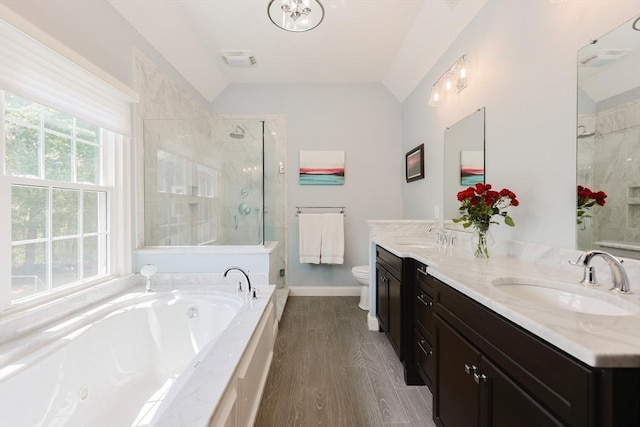 full bathroom with lofted ceiling, toilet, a stall shower, a garden tub, and double vanity