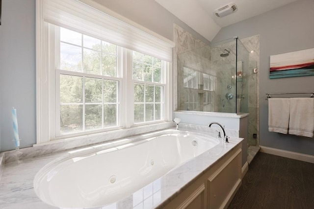 full bathroom featuring plenty of natural light, a stall shower, a whirlpool tub, wood finished floors, and vaulted ceiling