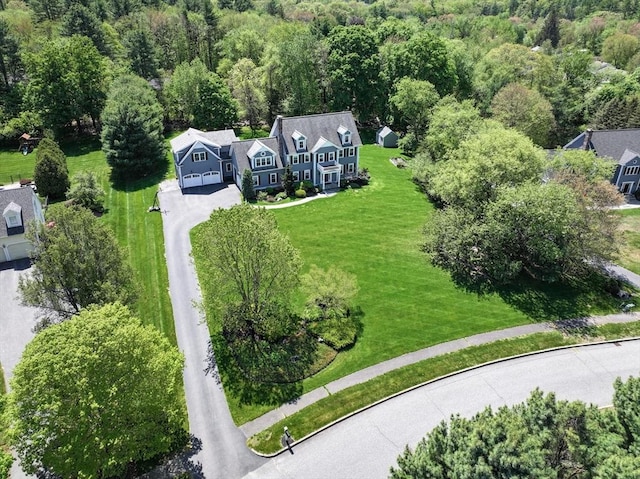 aerial view of property and surrounding area featuring a heavily wooded area