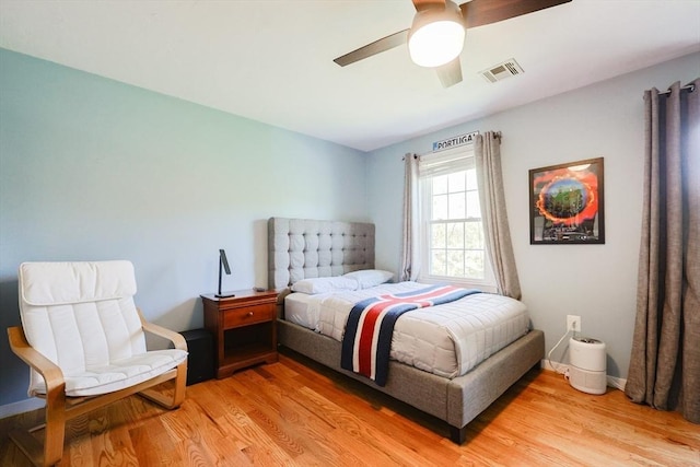 bedroom featuring light wood-type flooring, a ceiling fan, and baseboards