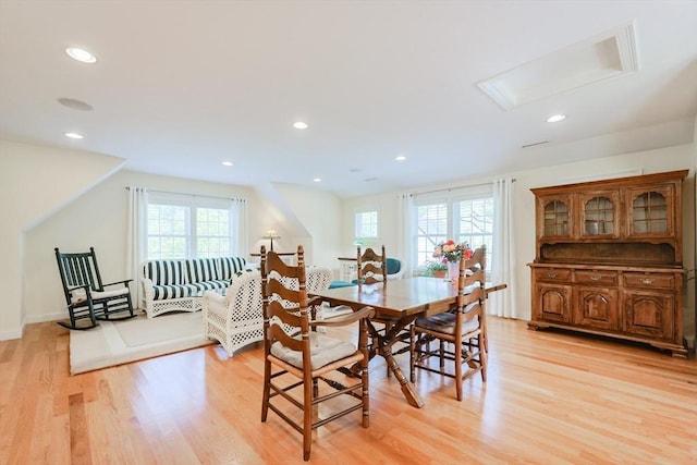 dining area with plenty of natural light, light wood-style floors, recessed lighting, attic access, and baseboards