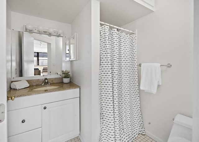 bathroom with tile patterned flooring, vanity, curtained shower, and toilet