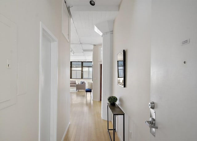 hallway with light hardwood / wood-style flooring