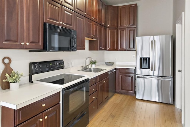 kitchen with light hardwood / wood-style floors, sink, and appliances with stainless steel finishes