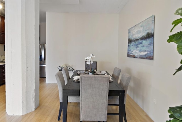 dining area featuring light hardwood / wood-style flooring and sink