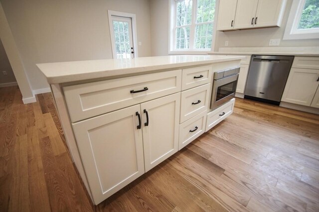 140 Tispaquin St, Middleboro, MA 02346 - kitchen with stainless steel appliances, light wood-type flooring, light countertops, and healthy amount of natural light