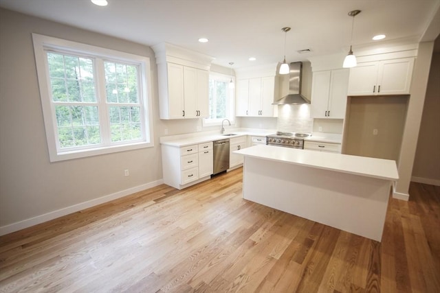 140 Tispaquin St, Middleboro, MA 02346 - kitchen with wall chimney range hood, appliances with stainless steel finishes, a sink, baseboards, and a kitchen island