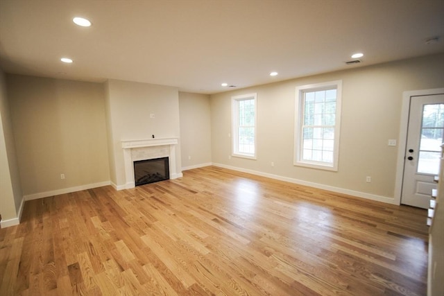 140 Tispaquin St, Middleboro, MA 02346 - unfurnished living room featuring recessed lighting, light wood-style floors, a fireplace, and baseboards