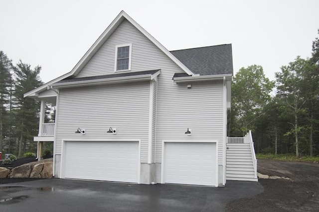 140 Tispaquin St, Middleboro, MA 02346 - view of home's exterior featuring a garage, asphalt driveway, and stairway