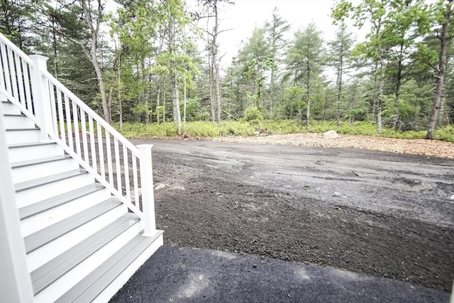 140 Tispaquin St, Middleboro, MA 02346 - view of yard with stairs, a wooded view, and driveway