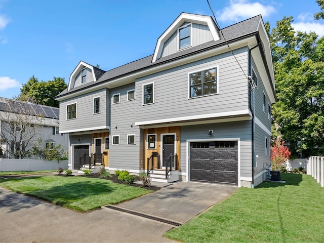 view of front of property with a garage, central air condition unit, and a front yard