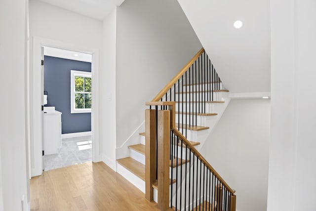 staircase featuring wood-type flooring