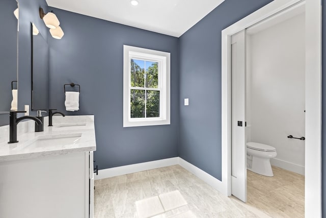 bathroom with toilet and vanity