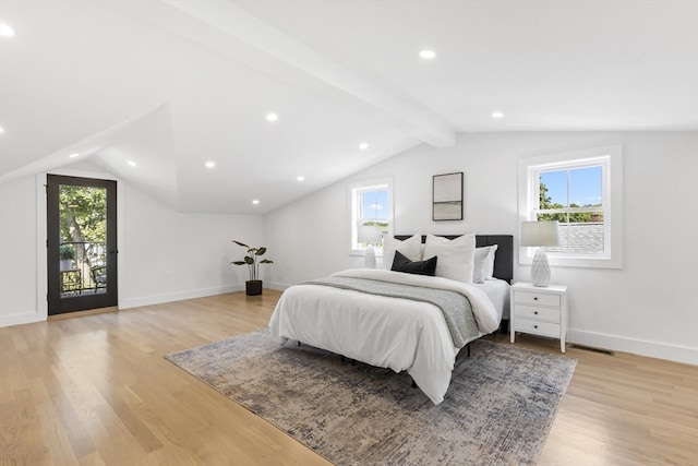 bedroom featuring light hardwood / wood-style floors, lofted ceiling with beams, and access to outside