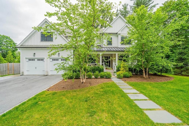 1 Putnam Rd, Bedford, MA 01730 - craftsman-style home featuring board and batten siding, asphalt driveway, a porch, a standing seam roof, and a garage