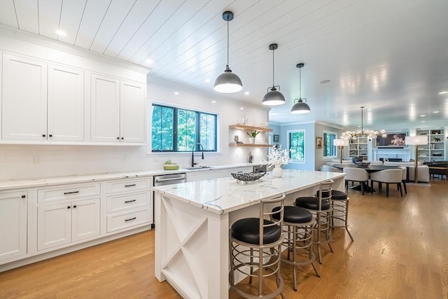 1 Putnam Rd, Bedford, MA 01730 - kitchen featuring open shelves, light wood-style flooring, white cabinetry, light stone countertops, and ornamental molding