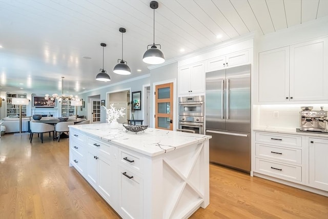 1 Putnam Rd, Bedford, MA 01730 - kitchen with appliances with stainless steel finishes, ornamental molding, open floor plan, white cabinetry, and light wood-style flooring