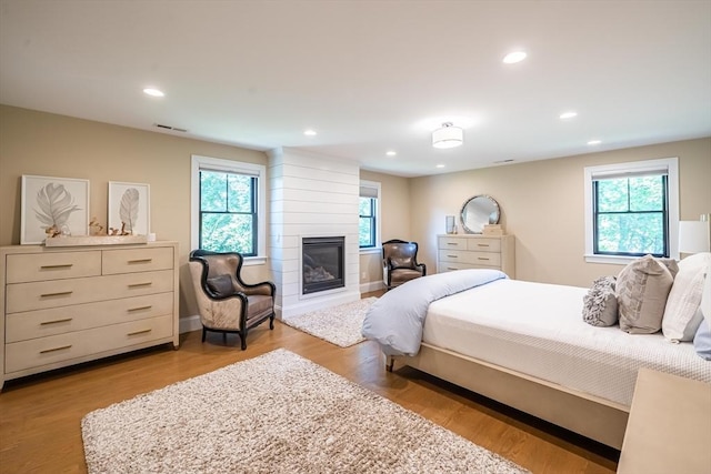 1 Putnam Rd, Bedford, MA 01730 - bedroom with a fireplace, recessed lighting, and wood finished floors