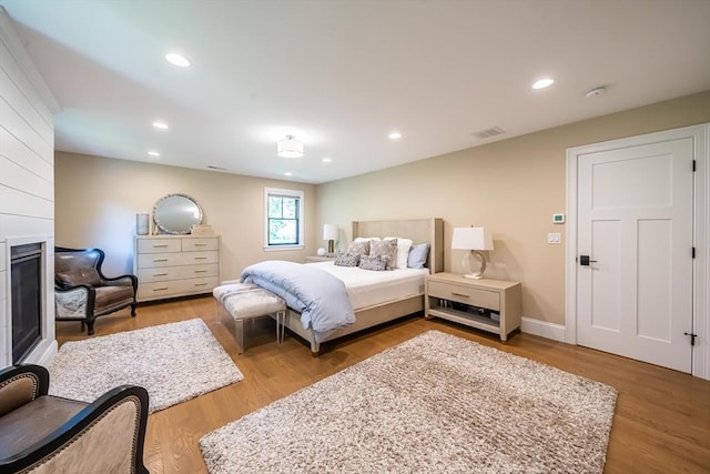 1 Putnam Rd, Bedford, MA 01730 - bedroom featuring a fireplace, wood finished floors, and recessed lighting