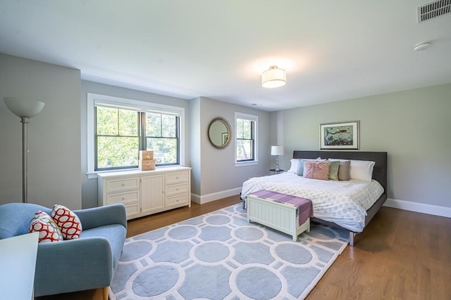 1 Putnam Rd, Bedford, MA 01730 - bedroom with multiple windows and dark wood-style flooring