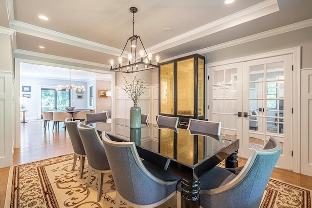 1 Putnam Rd, Bedford, MA 01730 - dining space featuring a chandelier, french doors, ornamental molding, wood finished floors, and a decorative wall