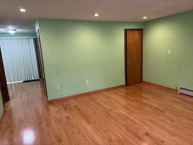 30 Wallace Cir Unit 30, Malden, MA 02148 - empty room featuring light wood-style flooring, baseboards, recessed lighting, and a baseboard heating unit