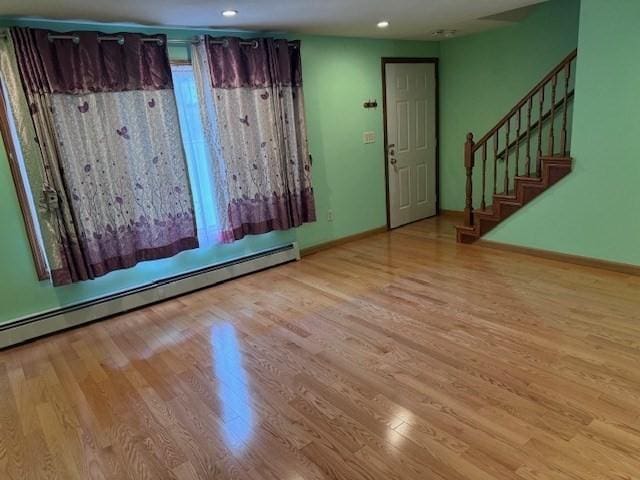 30 Wallace Cir Unit 30, Malden, MA 02148 - unfurnished room featuring a baseboard radiator, wood finished floors, baseboards, recessed lighting, and stairs