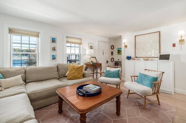 living area with baseboards and light wood-type flooring