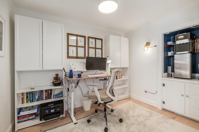 home office with baseboards and light wood-style floors