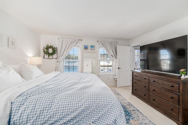 bedroom featuring light colored carpet