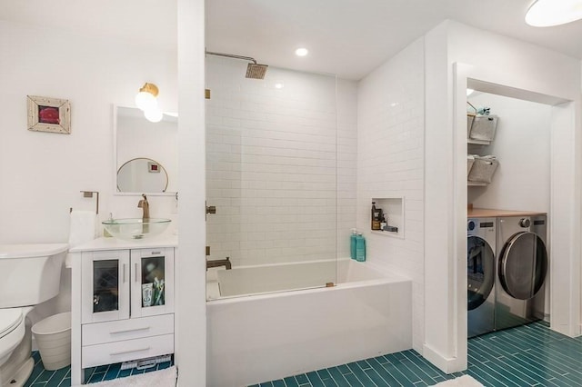 bathroom featuring tile patterned flooring, toilet, bathing tub / shower combination, independent washer and dryer, and vanity