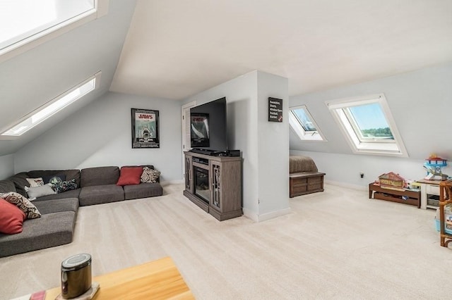 living area featuring vaulted ceiling with skylight and carpet floors