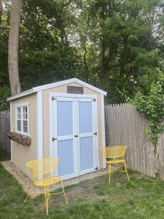 view of shed featuring fence