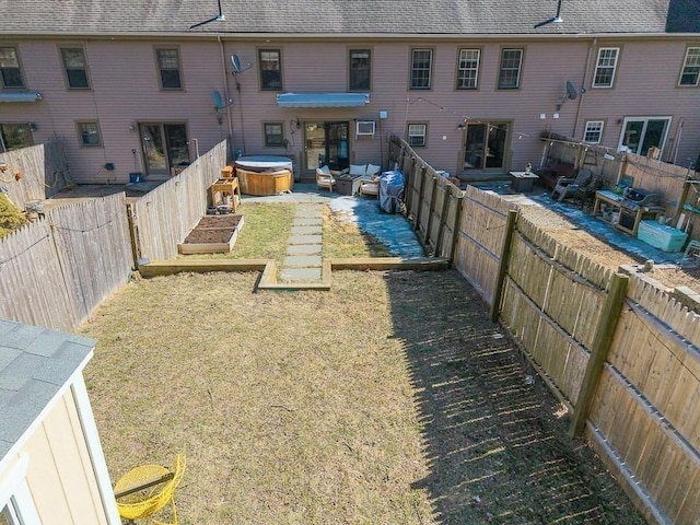 back of house featuring a yard, a fenced backyard, and a shingled roof