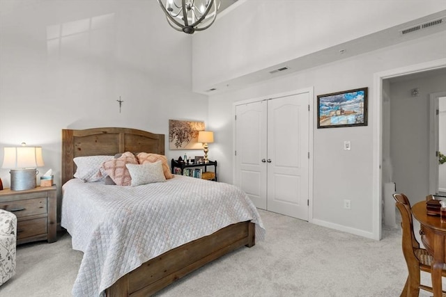 24 Merrimac Way Unit H, Tyngsborough, MA 01879 - bedroom featuring light colored carpet, a chandelier, a closet, baseboards, and a high ceiling