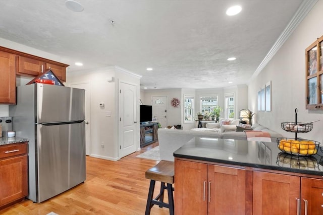 24 Merrimac Way Unit H, Tyngsborough, MA 01879 - kitchen with freestanding refrigerator, brown cabinetry, light wood finished floors, recessed lighting, and crown molding