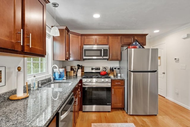 24 Merrimac Way Unit H, Tyngsborough, MA 01879 - kitchen with stainless steel appliances, a sink, light wood-style floors, dark stone counters, and crown molding