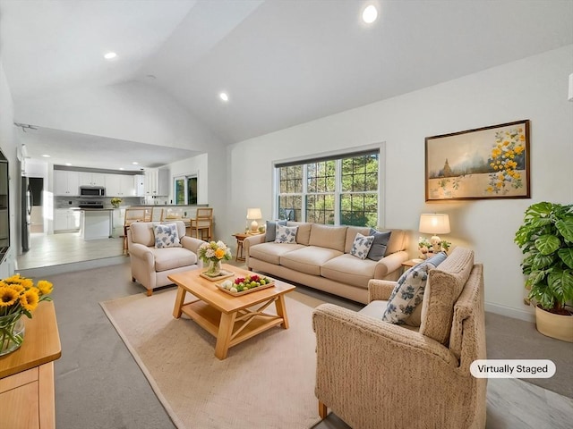 living room with baseboards, high vaulted ceiling, and recessed lighting