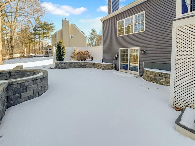 snow covered patio with fence