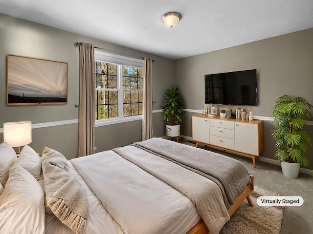 bedroom with light carpet and baseboards