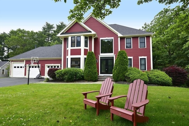 21 Hunt Dr, Stoughton, MA 02072 - view of front of property featuring a garage, driveway, a front yard, and roof with shingles