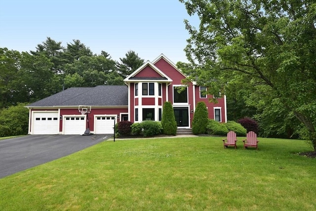 21 Hunt Dr, Stoughton, MA 02072 - view of front facade with a garage, driveway, and a front lawn