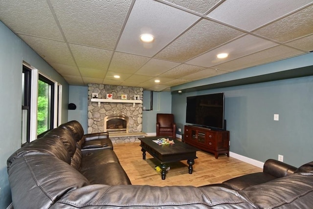 21 Hunt Dr, Stoughton, MA 02072 - living area with a drop ceiling, wood finished floors, a stone fireplace, and recessed lighting