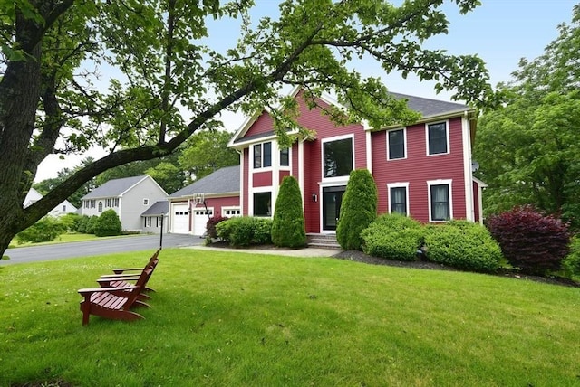 21 Hunt Dr, Stoughton, MA 02072 - view of front of property with asphalt driveway, a front yard, and a garage