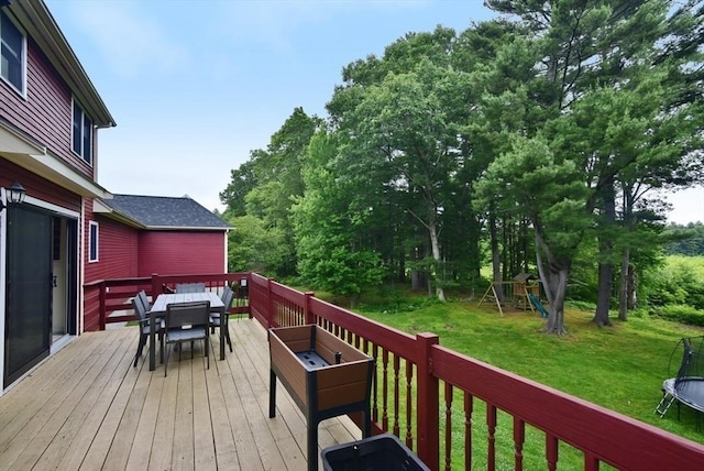 21 Hunt Dr, Stoughton, MA 02072 - wooden deck with a trampoline, outdoor dining space, a lawn, and a playground