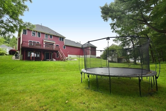 21 Hunt Dr, Stoughton, MA 02072 - view of grassy yard with a trampoline, stairs, and a deck