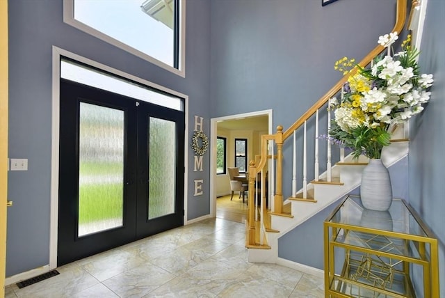 21 Hunt Dr, Stoughton, MA 02072 - entrance foyer with stairs, french doors, and a high ceiling