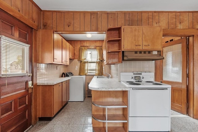 kitchen with white electric stove, under cabinet range hood, light countertops, open shelves, and washer and clothes dryer